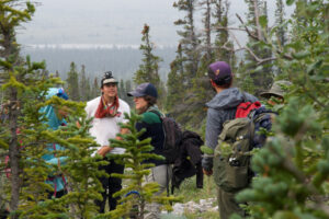 Chayce, Lucien, Chantel, Jona, and Laurent (from left to right) stand among spruce trees that are quite old and stunted by the strong winds in the Peel.